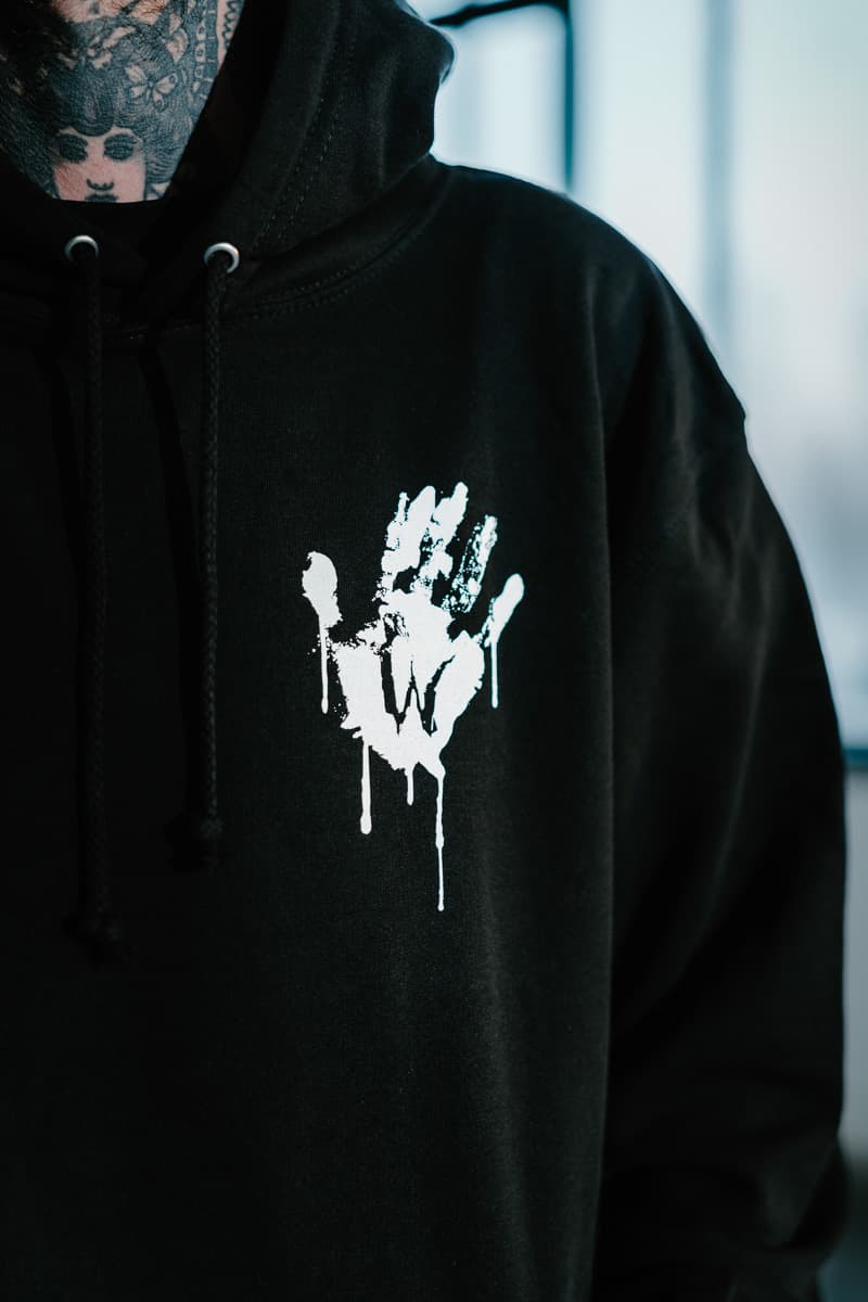 Black hoodie with WOLF MOTEL HOODIE UNISEX print - Wolfpack Clothing