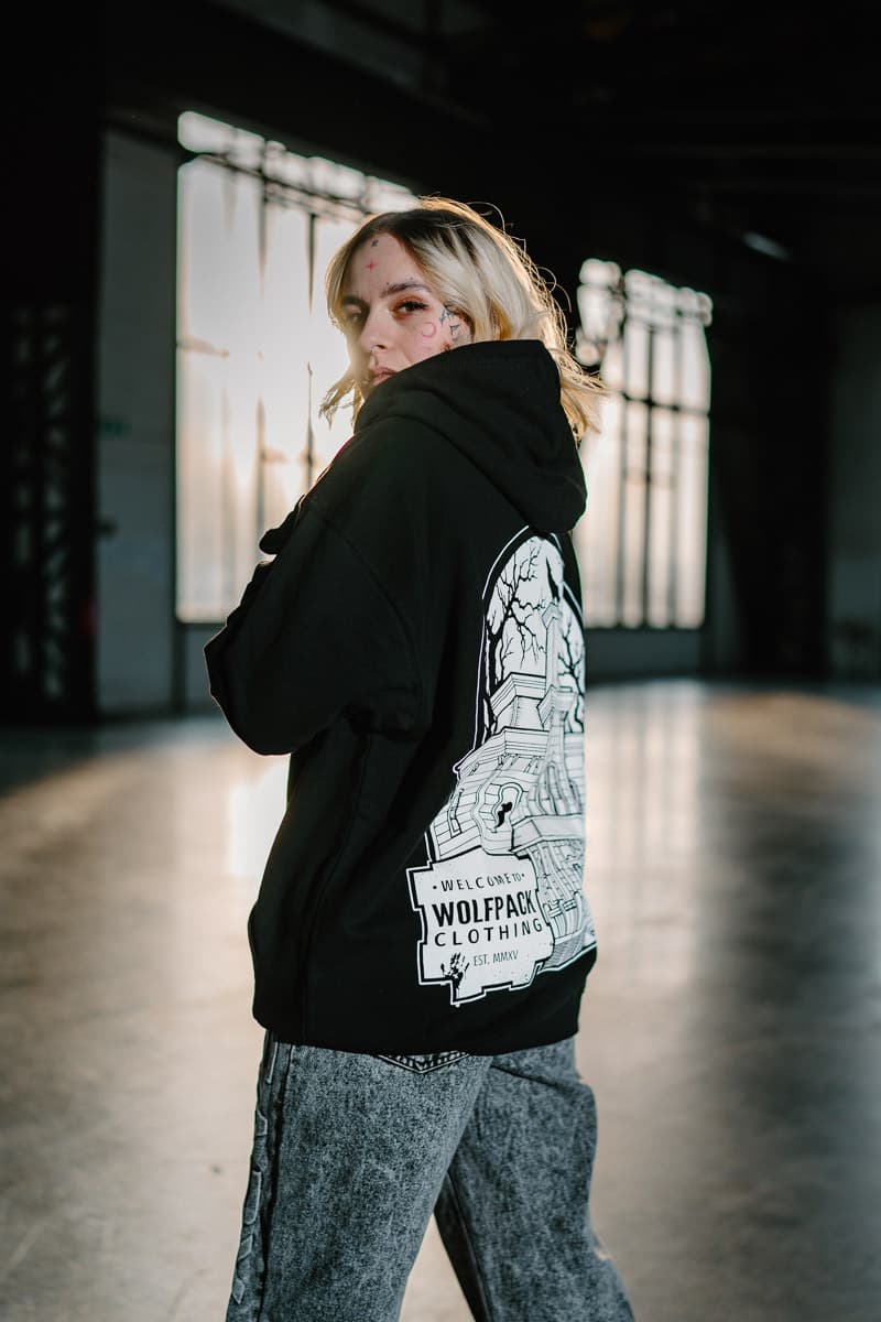 Black hoodie with WOLF MOTEL HOODIE UNISEX print - Wolfpack Clothing