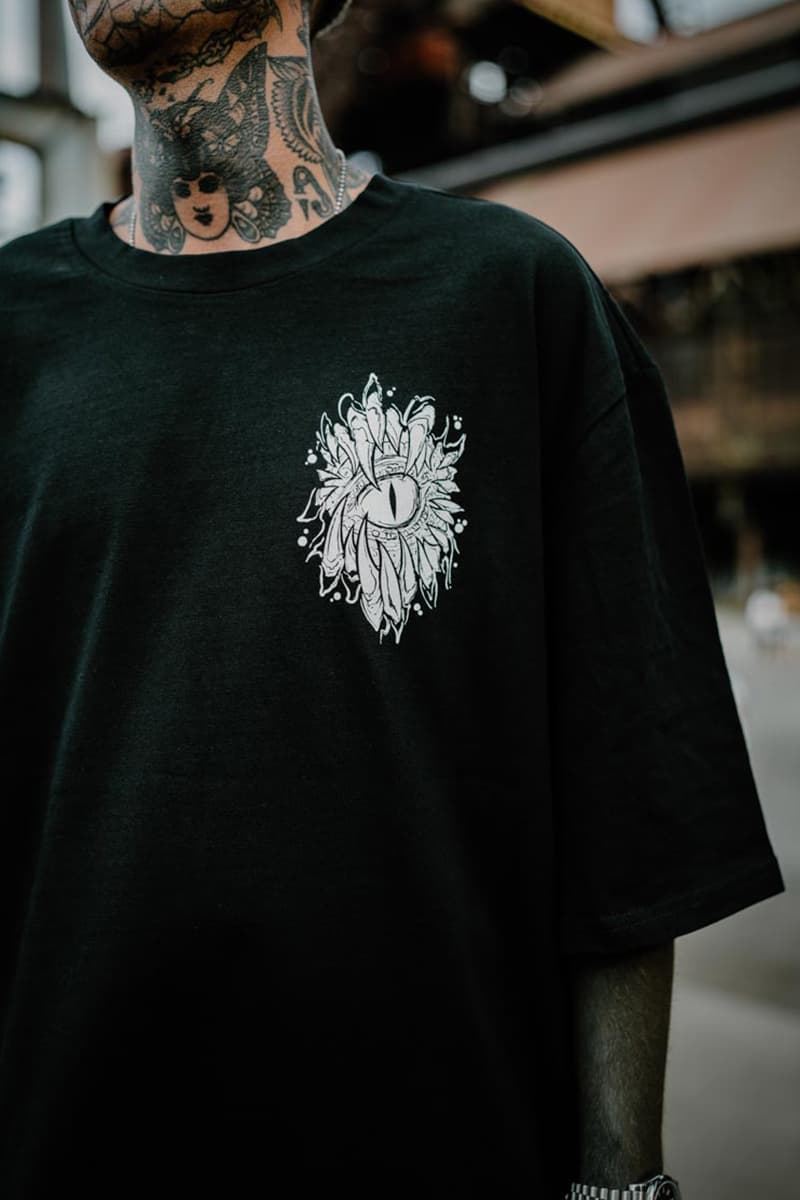 Black oversized t-shirt with SCALES & SILENCE OVERSIZED TEE UNISEX print - Wolfpack Clothing