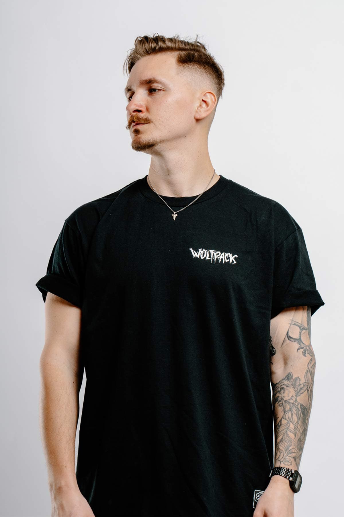 Black t-shirt with STERCORE x WOLFPACK TEE UNISEX print - Wolfpack Clothing