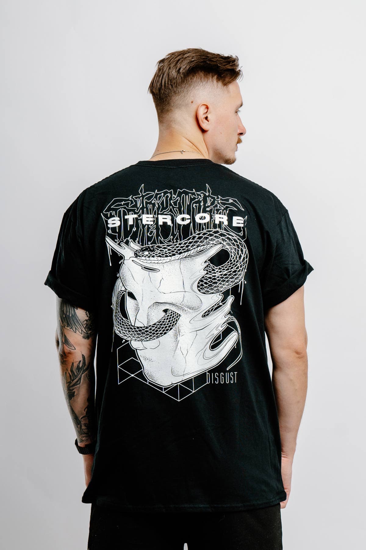 Black t-shirt with STERCORE x WOLFPACK TEE UNISEX print - Wolfpack Clothing